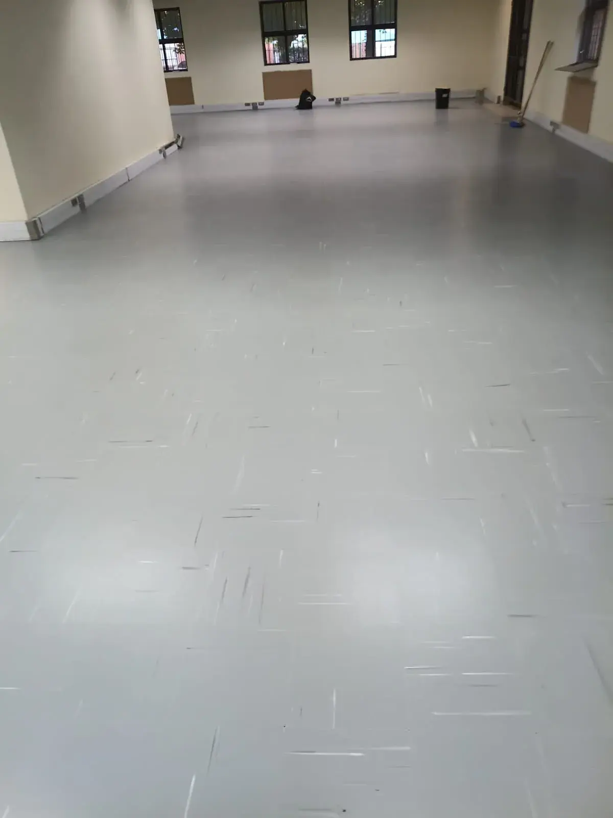 The same office from the same spot with a new light grey floor laid wall to wall.